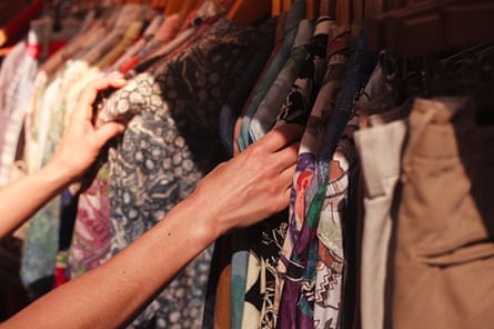 Browsing a rail of clothes at a street market