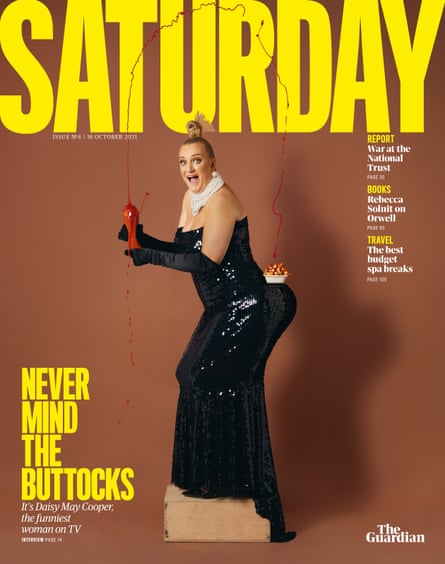 Daisy May Cooper on the cover of the Guardian’s Saturday magazine, wearing an evening dress and squirting ketchup from a bottle in her hands on to a portion of chips balanced on her bottom