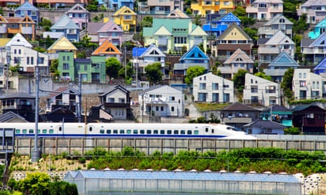 Flat-pack paradise … a bullet train passes through a suburb in Kanagawa, Japan.
