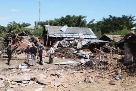 People inspect their damaged home after bombardments carried out by Myanmar’s military in Tabayin on 6 December.