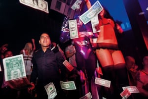 A VIP guest “makes it rain” with hundreds of one dollar bills