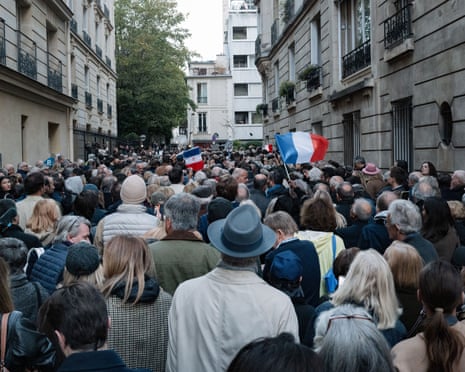 Supporters of France’s former president Nicolas Sarkozy gather outside his residence on 21 October 2025.