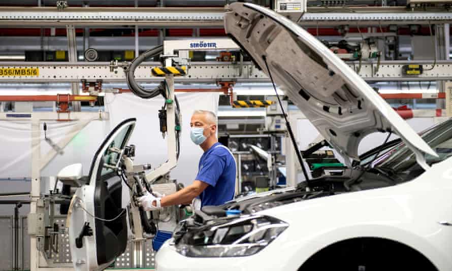 A worker wears a protective mask at the Volkswagen assembly line