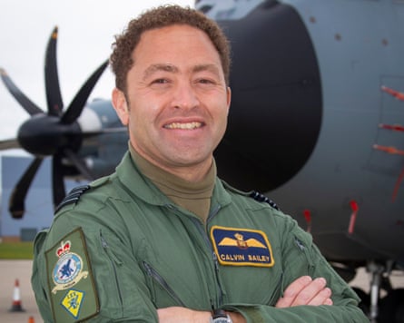 Calvin in a flight suit stood next to a large airplane