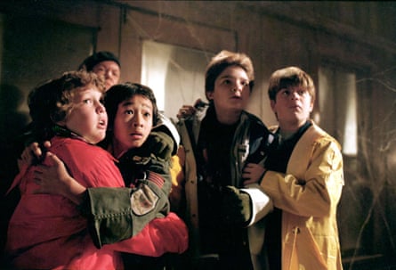 Four young boys looking frightened by something unseen in. the film The Goonies.