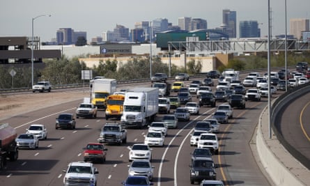 Early rush hour traffic rolls along I-10 in Phoenix.