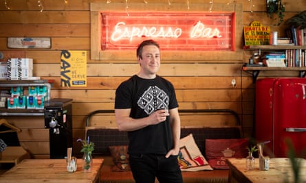 Paul Ashby holds a coffee cup in his very pleasant-looking cafe