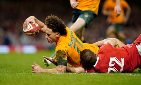 Australia's Mark Nawaqanitawase dives over to score the second of his two tries for Australia against Wales.