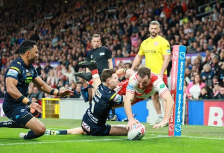 Hull KR’s Joe Burgess dives over in the corner despite Jai Field’s tackle.