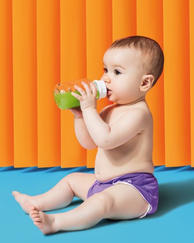 Baby drinking green juice