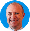 man smiling against blue background