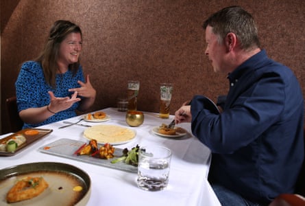Nyree and Karl eating and chatting across a restaurant table