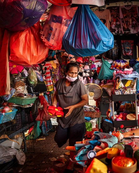A shop owner removes merchandise from a store