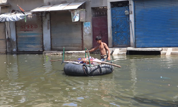 A man carries his belongings on a charpoi and tyre in Khairpur Nathan Shah