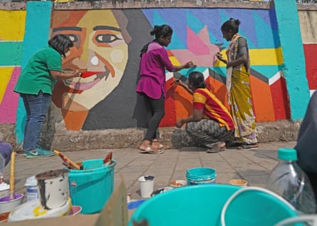 Members of Yaariyan, the youth initiative of the Humsafar Trust, paint a mural called Queering The City outside the gates of Sion Hospital in Mumbai, India.