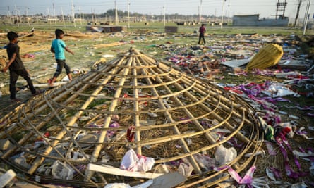 Indian villagers search for reusable materials at a religious camp after the end of Kumbh Mela.