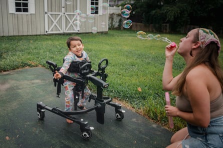 Gabrielle Lopez blows bubbles for her son, Esau, astatine their location successful Levittown, PA, US, August 2025
