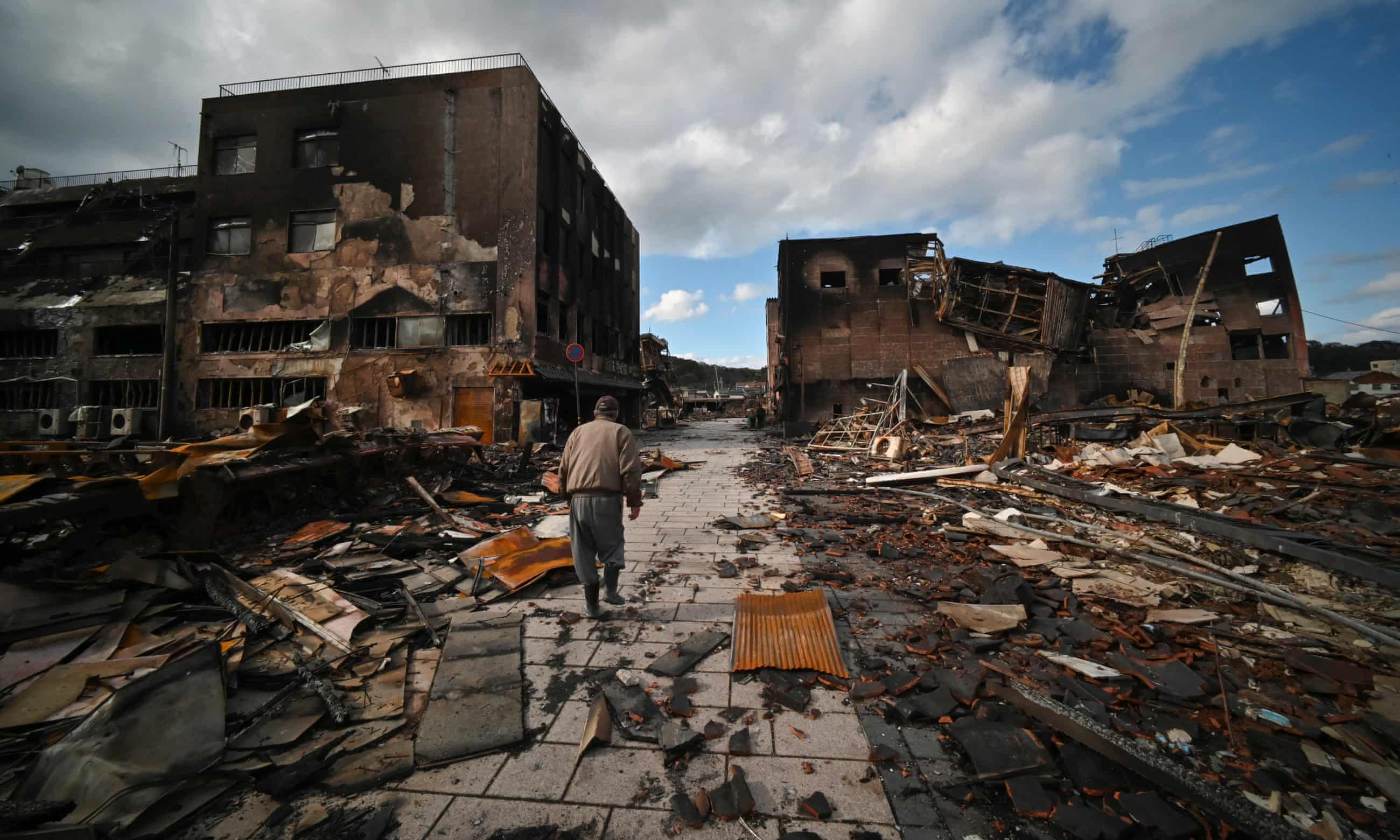 A man walks through the ruins of a shopping district in the city of Wajima, Ishikawa prefecture, Japan after an earthquake. Photograph: AFP/Getty Images