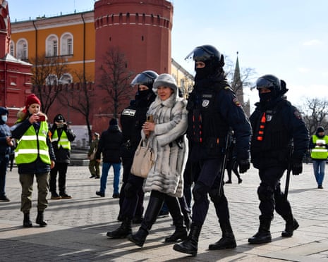 Police detain a woman during a protest against Russian military action in Ukraine, in Manezhnaya Square in central Moscow on 13 March.