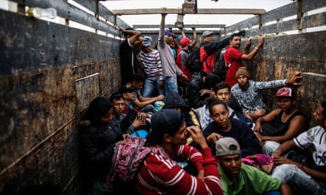 Venezuelan migrants travel aboard a truck in Tumbes, Peru, near the Ecuador border, on 1 November. 