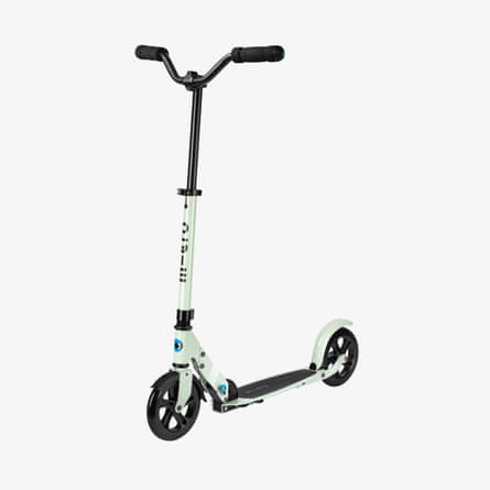 A pale green folding kick scooter with black handlebars and large black wheels