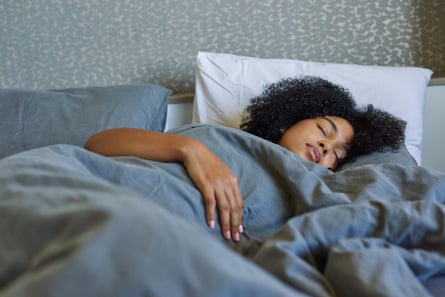 A young woman sleeping in her bed at home
