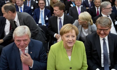 Chancellor Angela Merkel between the CEO of Deutsche Boerse, Theodor Weimer (right) and Hesse’s prime minister, Voilker Bouffier (left)