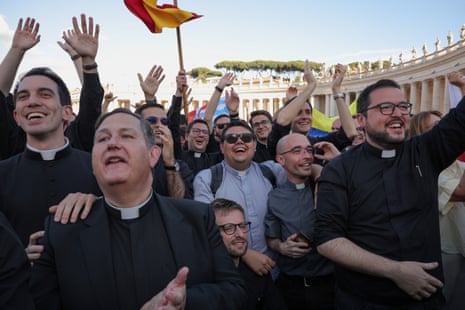 Priests react to white smoke from the chimney on the Sistine Chapel, indicating that a new pope has been elected.