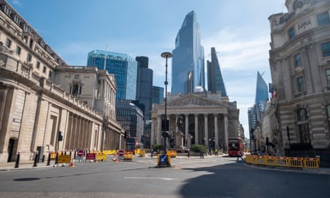 The Bank of England amid the tall towers of the City of London financial district.