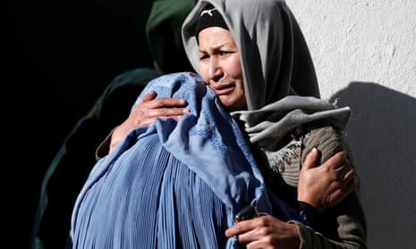 Afghan women mourn inside a hospital compound after a suicide attack in Kabul.
