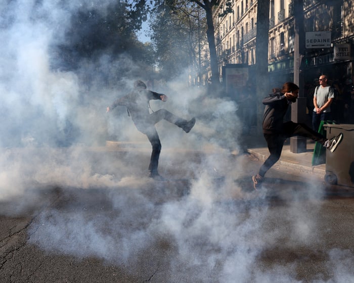 Police fire teargas at striking protesters in Paris – video