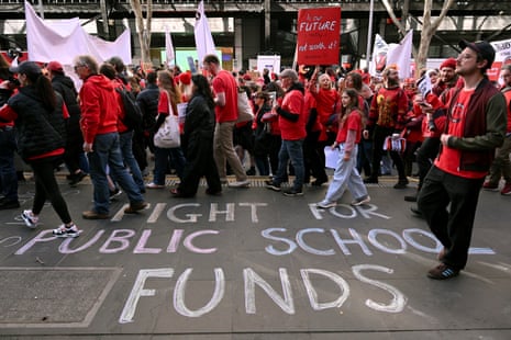 Teachers march through Melbourne's city centre to protest over pay and conditions earlier this month.