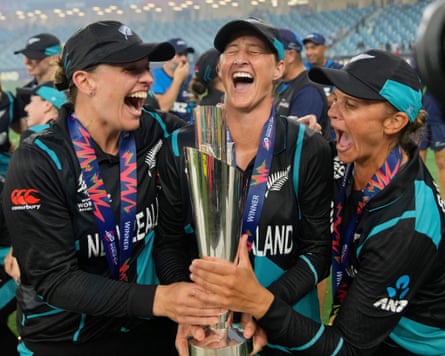 The New Zealand cricketers Lea Tahuhu (left), Sophie Devine (centre) and Suzie Bates (right) celebrate with the Women’s T20 World Cup trophy after helping their team win the tournament in 2024.