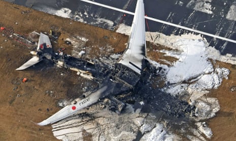 An aerial view shows burnt Japan Airlines' (JAL) Airbus A350 plane