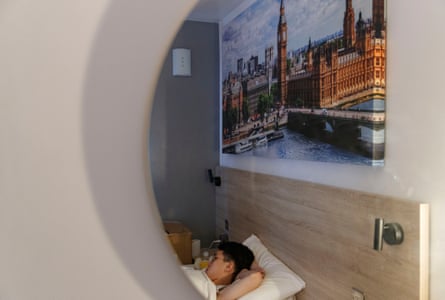 An asylum seeker from Hong Kong lying in bed in a hotel room
