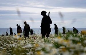 Statues of soldiers with ocean in background