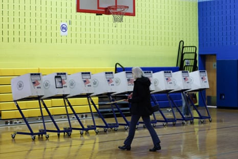 a person walks toward voting booths