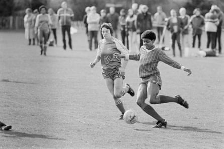 Young people playing football during a training session by the England squad in 1984.