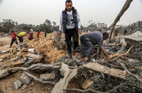 Palestinians examine the aftermath of an Israeli attack in Rafah, on Thursday.
