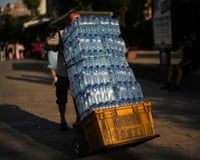 A man delivers bottles of water to a restaurant in Istanbul, Turkey on a hot summer’s day last year