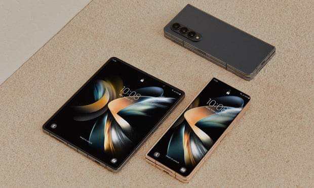 The Samsung Galaxy Z Fold 4 pictured open, closed and face down on a table.