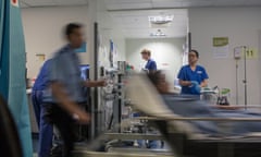 A blurred image of doctors, nurses and staff busy at work in an accident and emergency ward in a British hospital