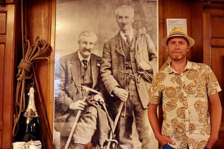 Leo Houlding in Wasdale Head Inn with a photo of the Abraham brothers who took the famous photo of Napes Needle.