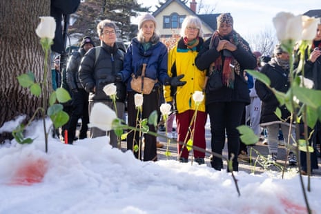 Community members pray at the scene where a federal agent shot and killed Renee Nicole Good, 37, of the Twin Cities earlier on Portland Avenue in Minneapolis on Wednesday, Jan. 7, 2026.
