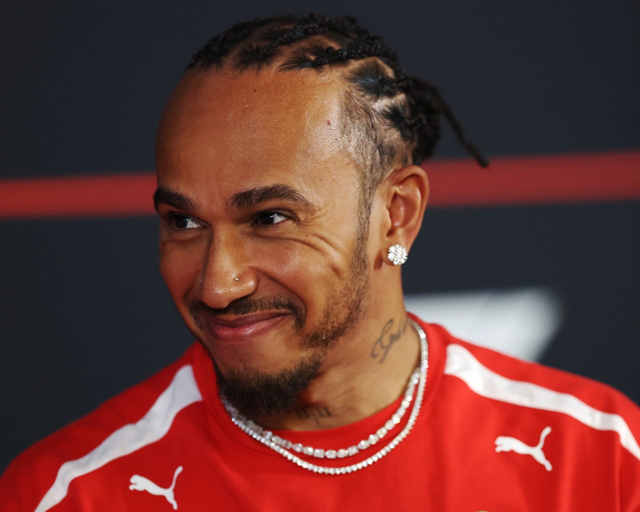 The Formula One driver Lewis Hamilton smiles during a press conference.