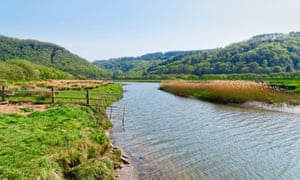 Clear rippled water of the River Dwyryd flowing across a meadow