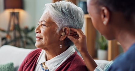 Woman getting a hearing aid fitted