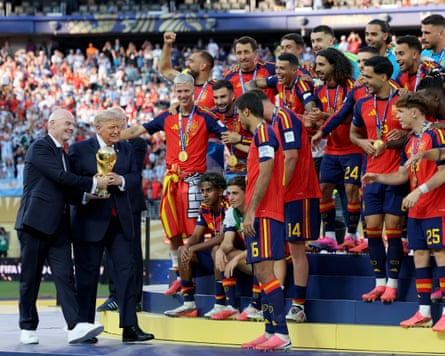 Infantino and Trump hand the trophy to Rodri of Spain as the rest of the Spain team look on