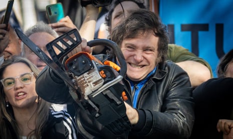 Javier Milei with a chainsaw and a manic look on his face at a rally in San Martin, Buenos Aires, Argentina.