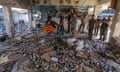 Palestinians search for missing people under the rubble of a destroyed Unrwa-run school in the Nuseirat refugee camp, central Gaza.